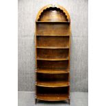 An unusual 1930's arch topped graduated bookcase, W. 62cm. H 174cm.
