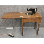 A vintage sewing machine in cabinet, 61 x 79cm.
