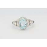 A 925 silver ring set with an oval cut blue topaz and white stones, (O).