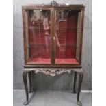 An attractive carved beechwood display cabinet, W. 92cm. H. 157cm.