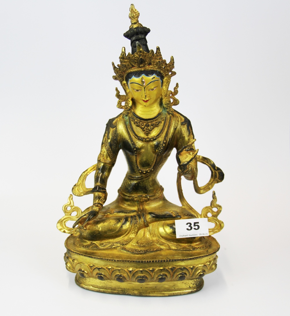 A Tibetan temple quality figure of a seated Tara with hand painted face, H. 34cm.