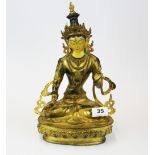 A Tibetan temple quality figure of a seated Tara with hand painted face, H. 34cm.