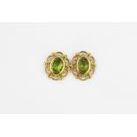 A pair of 9ct yellow gold earrings set with oval cut peridots, L. 1.5cm.