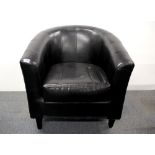 A leather upholstered tub chair.