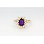 A 14ct yellow gold cluster ring set with an oval cut amethyst surrounded by pearls, (M).