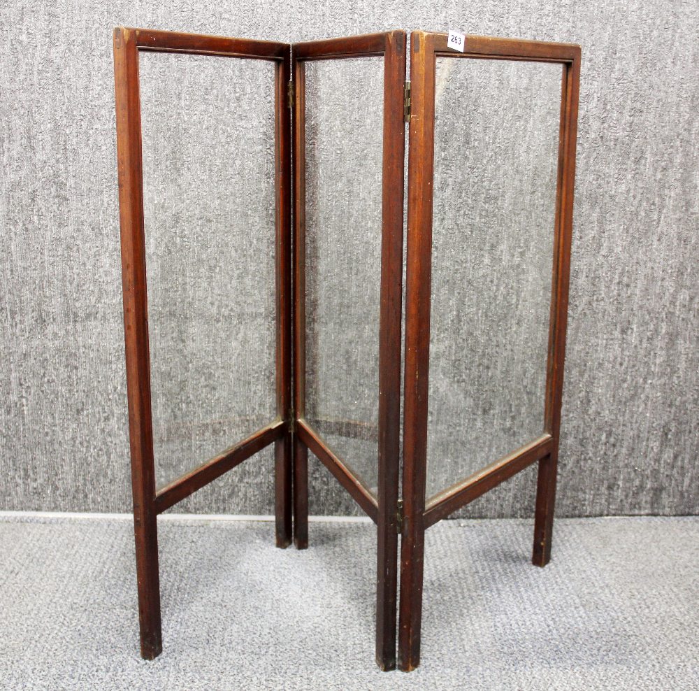 An Edwardian mahogany and glass three fold fire screen, panel size 46 x 91cm.