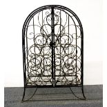 A vintage wrought iron wine rack, H. 73cm. W. 52cm. D. 32cm.