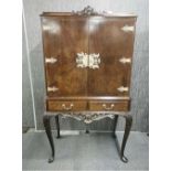 A 1950's beechwood drinks cabinet, W. 92cm. H. 159cm. A/F to top.