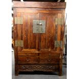 A superb large 19th Century Chinese wooden cabinet over three drawers with bronze/brass fittings,