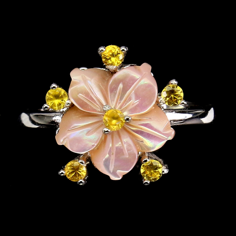 A 925 silver ring set with carved mother of pearl and fancy yellow sapphires, (O.5).