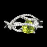 A 925 silver ring set with a trillion cut peridot and white stones, ®.