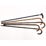 A group of five vintage walking sticks including one with silver collar.