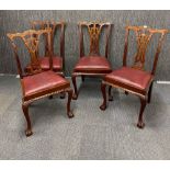 A set of four 1920's carved mahogany ball and claw foot dining chairs.