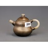 A Chinese pewter overlaid terracotta tea pot with mutton fat jade spout and handles. H. 10cm spout