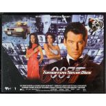 An framed James Bond 007 movie film poster for Tomorrow Never Dies. Frame size H. 105cm W. 180cm.