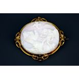A large antique yellow metal (tested minimum 9ct gold) brooch set with a carved pink and white shell