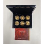 A boxed set of VE day 70th anniversary "golden" crowns decorated with enamels.