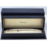 An 18ct white gold (stamped 750) Chopard Happy diamonds bracelet set with a brilliant cut diamond,