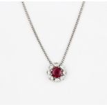 An 18ct white gold (stamped 750) necklace set with a ruby surrounded by brilliant cut diamonds,
