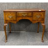 A 1930's walnut veneered mahogany three drawer desk, W. 91cm.