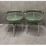 A pair of 'racing' green leather upholstered Le Corbusier - Pierre Jeaneret Cassina LC7 swivel