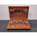 A teak cased 1970's Webber and Hill stainless steel cutlery set.