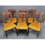 A set of six Edwardian carved mahogony upholstered dining chairs. Matching lots 305 and 306.