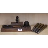 A 1940's rosewood and bakelite smokers stand together with four WW2 shell cases.