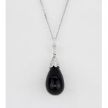 A 9ct white gold (stamped 375) pendant and chain set with an onyx drop and brilliant cut diamonds,
