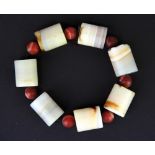 A group of banded agate beads currently loosley threaded as a bracelet, bead size H. 2.8cm, L. 2.