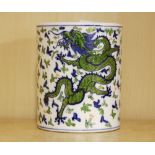 A Chinese hand painted porcelain brush pot decorated with underglaze blue and overglazed red dragons
