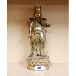 A Tibetan gilt bronze figure of a Buddhist guardian deity H. 29cm.