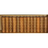 Thirteen volumes, half leather bound, of works by William Makepeace Thackery, published by the