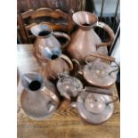 A set of four graduated Victorian copper measuring jugs, largest H. 34cm, together with three