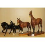 A large Beswick porcelain figure of Red Rum (A/F). Together with three further of Beswick horse