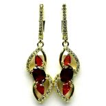 A pair of 925 silver gilt earrings set with oval and pear cut garnets, L. 4cm.