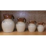 A graduated set of 19th Century stoneware jugs, largest H. 19cm.