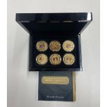 A cased set of twelve 24ct gold finished and enamelled Imperial one crown coins.