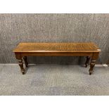 A heavy quality carved oak bench, L. 122cm.