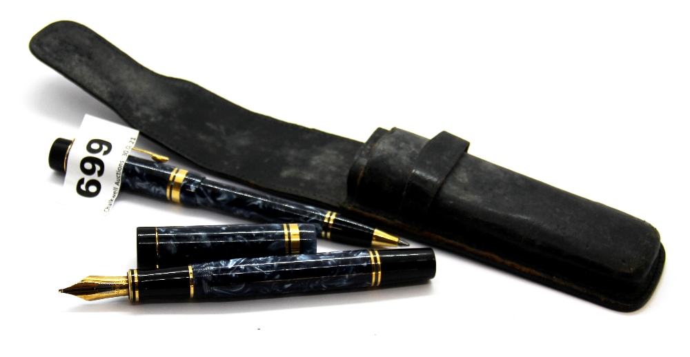 A Parker fountain pen with 18ct gold nib and an accompanying ball pen in a leather case.