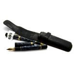 A Parker fountain pen with 18ct gold nib and an accompanying ball pen in a leather case.