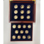 A case of 20 Alderney gold plated British monarch silver 5 pound coins.