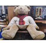 A very large Harrods stuffed teddy bear, H. 120cm W. 100cm.