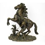 A superb French cast bronze figure of a horse and handler, signed Coustou H. 39cm.