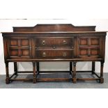 A 1920's carved oak Jacobean style sideboard, W. 183cm H. 110cm.