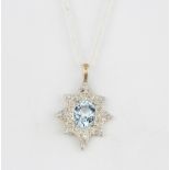 A yellow and white metal (tested minimum 9ct gold) pendant set with an oval cut aquamarine and