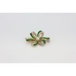 A yellow metal (tested minimum 9ct gold) green enamelled brooch set with old cut diamonds and a