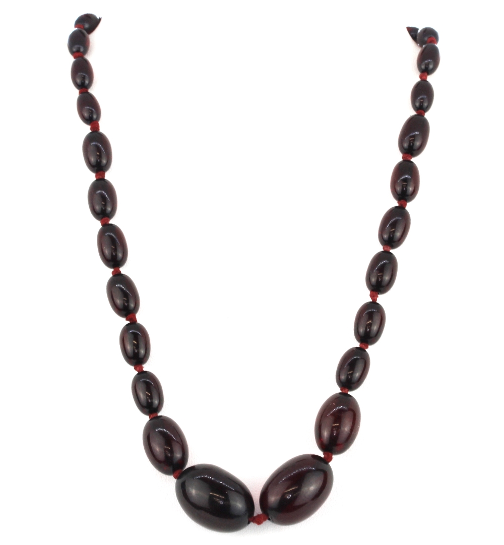 A vintage graduated cherry amber necklace, approx. 47cm.