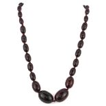 A vintage graduated cherry amber necklace, approx. 47cm.