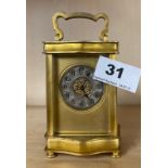 A small French gilt brass carriage clock with silver-gilt dial.
